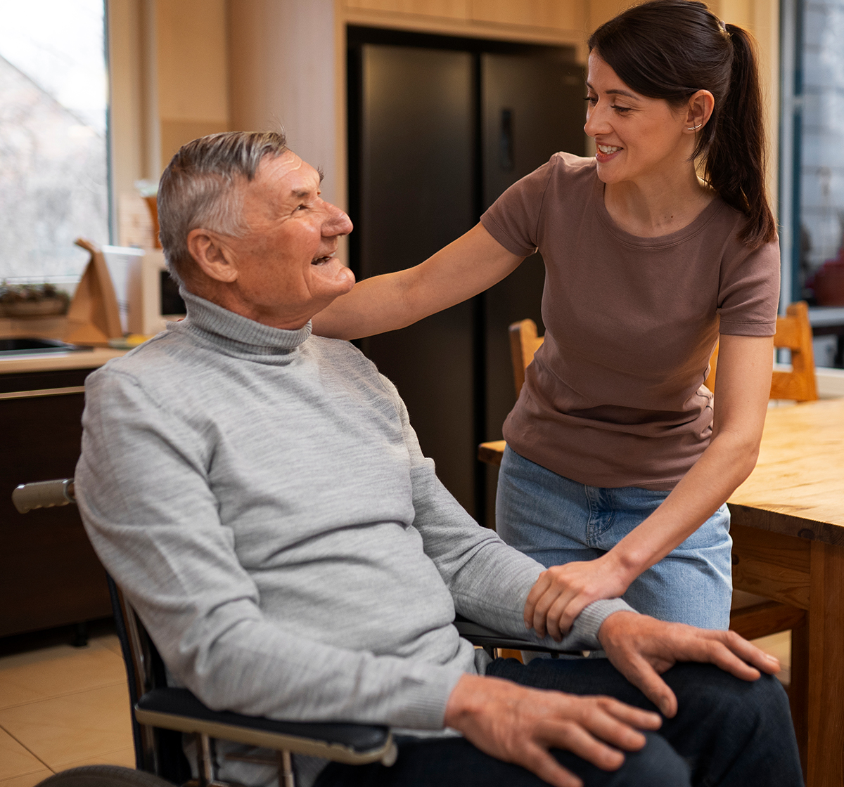 psychologist-08 A friendly care worker chats with an elderly man in his wheelchair at home